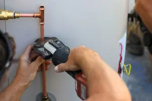  Plumber repairing water heater